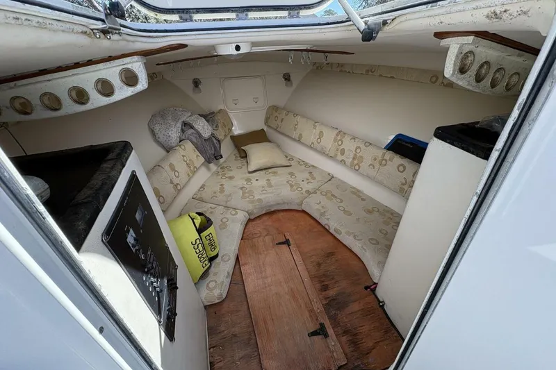 Slide: The Image of Interior of 2008 Wellcraft 35 Scarab Sport boat with cozy seating and storage. - 12