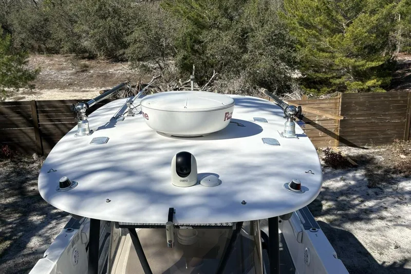 Slide: The Image of 2008 Wellcraft 35 Scarab Sport boat with radar and antennas, surrounded by trees. - 13