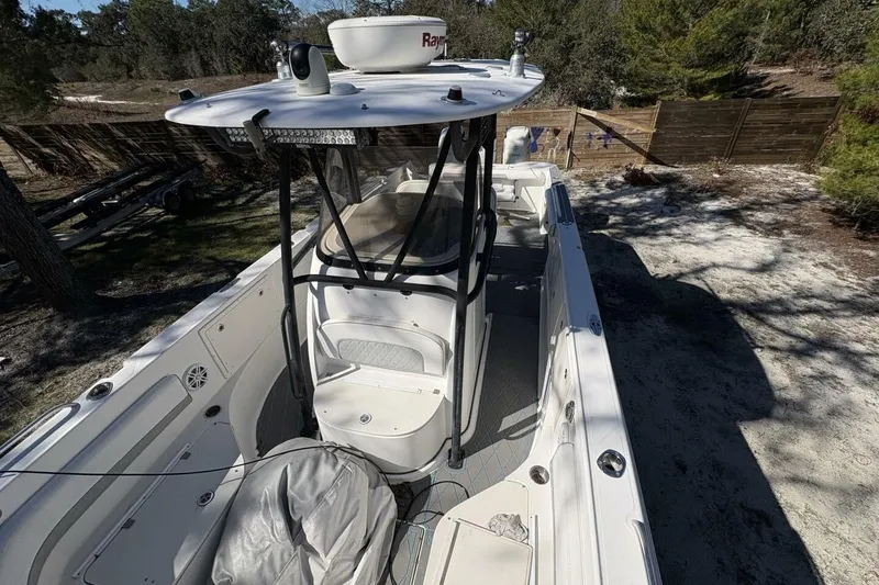Slide: The Image of 2008 Wellcraft 35 Scarab Sport boat with center console and radar, parked outdoors. - 14