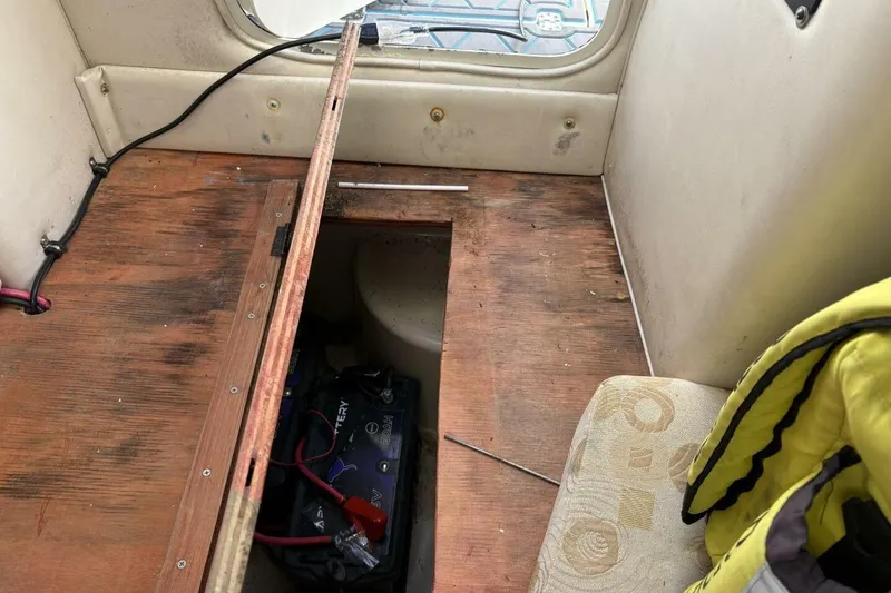 Slide: The Image of 2008 Wellcraft 35 Scarab Sport interior with open hatch revealing battery compartment. - 20