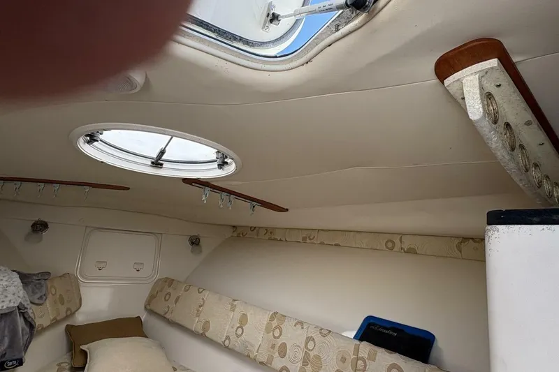 Slide: The Image of Interior cabin of 2008 Wellcraft 35 Scarab Sport, featuring circular hatch and cushioned seating. - 28