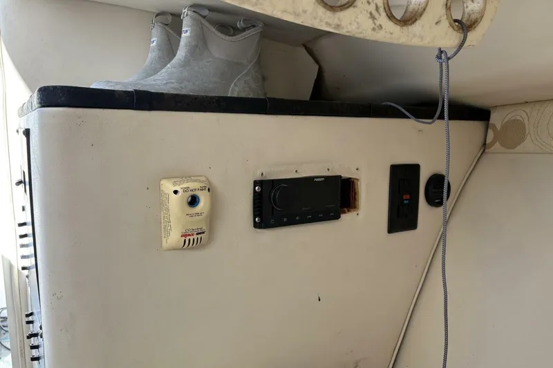 Slide: The Image of 2008 Wellcraft 35 Scarab Sport interior with control panel and boots. - 32