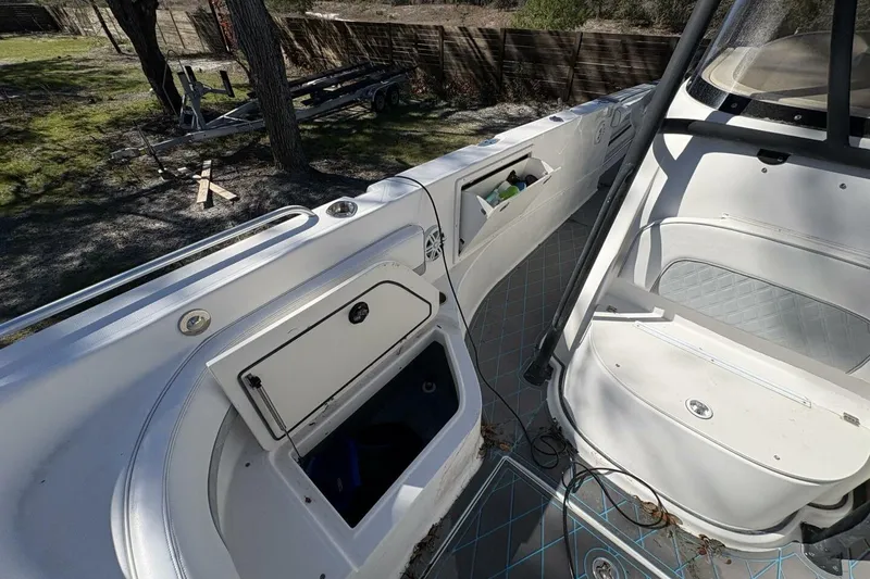 Slide: The Image of 2008 Wellcraft 35 Scarab Sport boat interior with storage compartments and seating. - 37