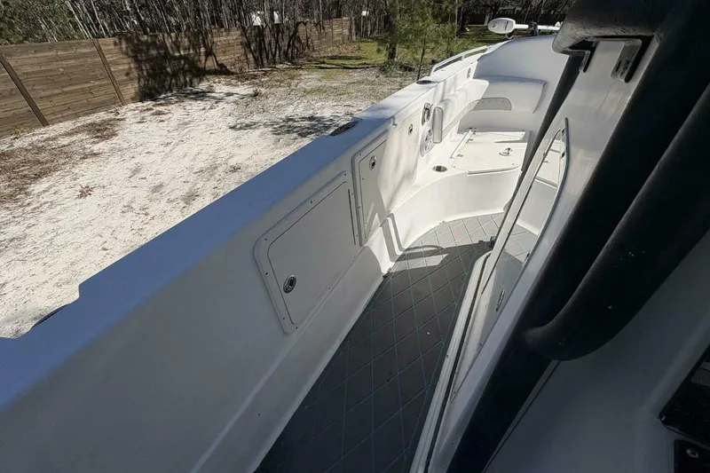 Slide: The Image of 2008 Wellcraft 35 Scarab Sport boat interior with white deck and storage compartments. - 39