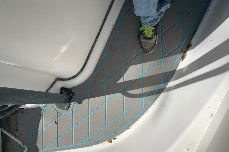 Slide: The Image of 2008 Wellcraft 35 Scarab Sport deck with blue grid pattern and a person's foot. - 41