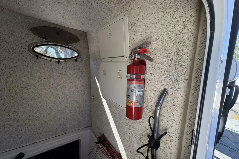 Slide: The Image of Interior of 2008 Wellcraft 35 Scarab Sport with fire extinguisher and porthole. - 46