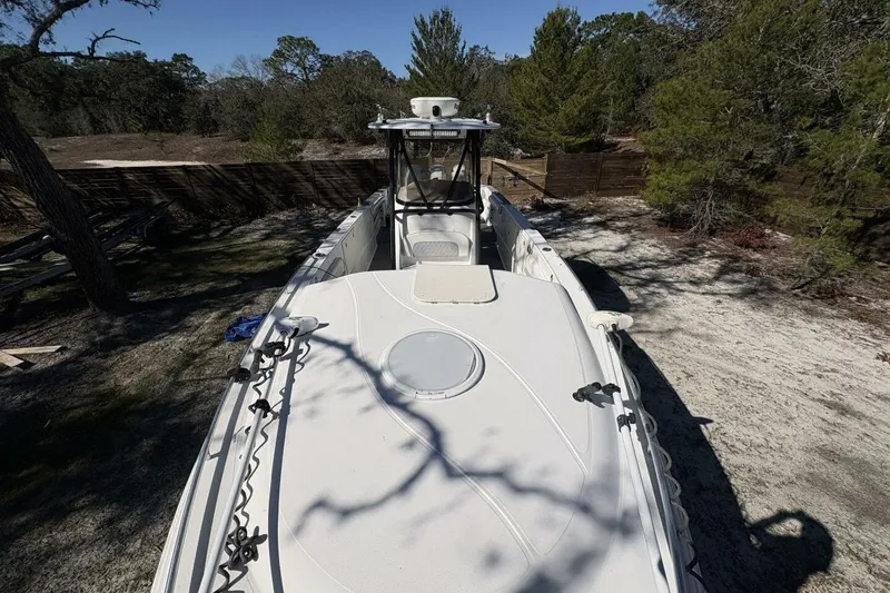 Slide: The Image of 2008 Wellcraft 35 Scarab Sport boat on land, surrounded by trees. - 5