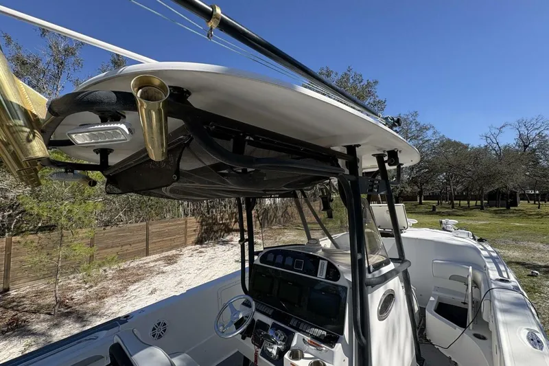 Slide: The Image of 2008 Wellcraft 35 Scarab Sport boat with T-top and fishing rod holders. - 52