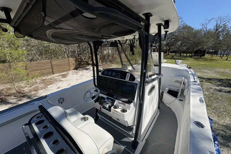 Slide: The Image of 2008 Wellcraft 35 Scarab Sport boat interior with helm, seating, and console in outdoor setting. - 53
