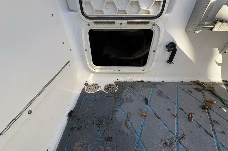 Slide: The Image of Open hatch on 2008 Wellcraft 35 Scarab Sport boat with leaves on deck. - 60
