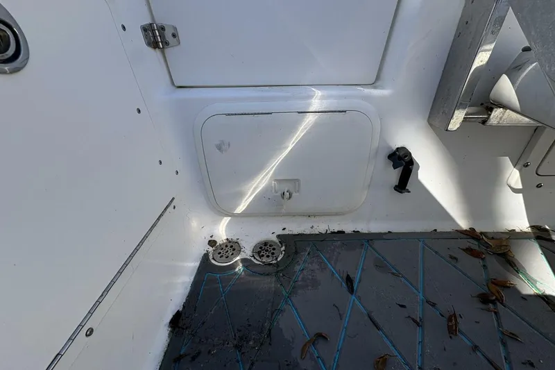 Slide: The Image of 2008 Wellcraft 35 Scarab Sport boat interior with storage compartment and drains. - 61