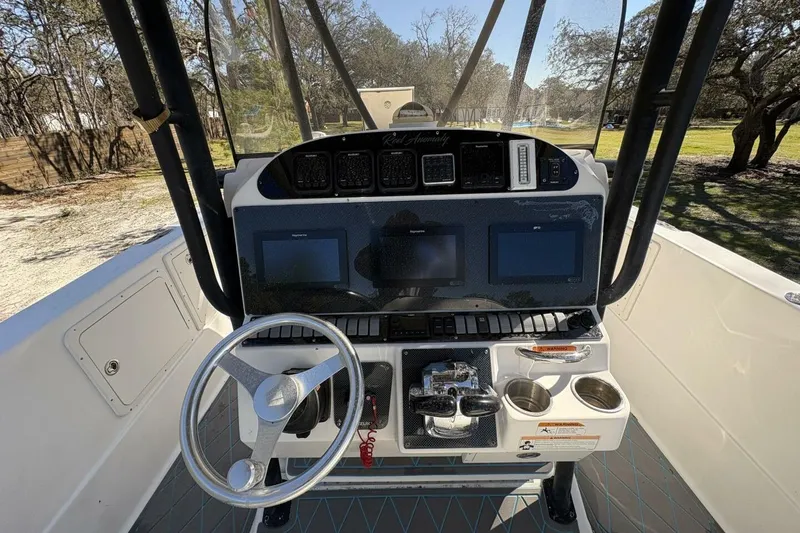 Slide: The Image of 2008 Wellcraft 35 Scarab Sport boat dashboard with steering wheel and navigation screens. - 70