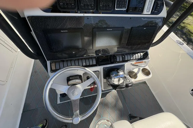 Slide: The Image of 2008 Wellcraft 35 Scarab Sport dashboard with steering wheel, controls, and navigation screens. - 72