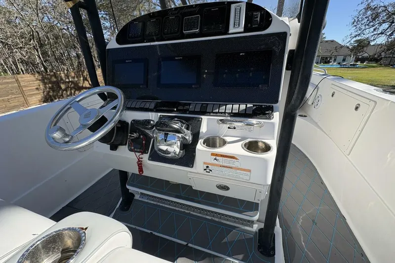 Slide: The Image of 2008 Wellcraft 35 Scarab Sport boat console with steering wheel and navigation screens. - 8