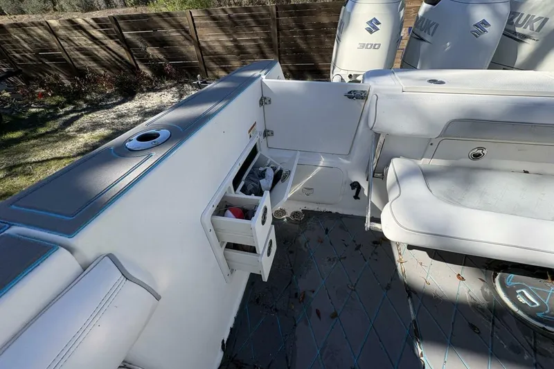 Slide: The Image of 2008 Wellcraft 35 Scarab Sport boat interior with storage drawers and Suzuki engines. - 82