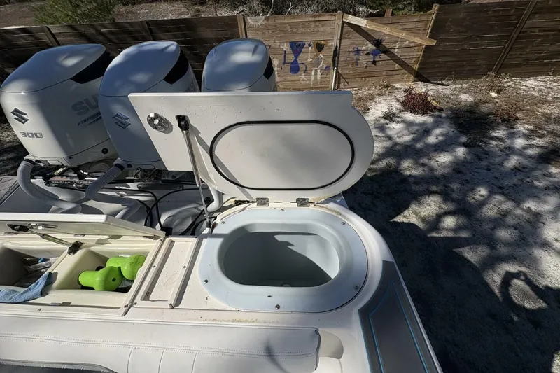 Slide: The Image of 2008 Wellcraft 35 Scarab Sport boat with Suzuki engines and open storage compartment. - 86