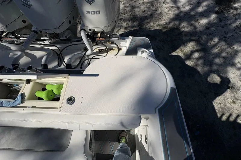 Slide: The Image of 2008 Wellcraft 35 Scarab Sport boat deck with storage compartment and twin 300 HP engines. - 88