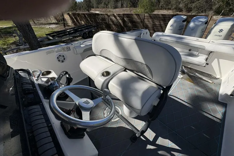 Slide: The Image of 2008 Wellcraft 35 Scarab Sport boat interior with steering wheel and seating. - 9