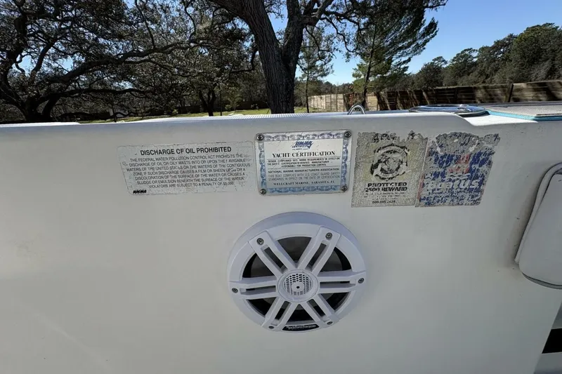 Slide: The Image of 2008 Wellcraft 35 Scarab Sport boat with certification labels and speaker on deck. - 91