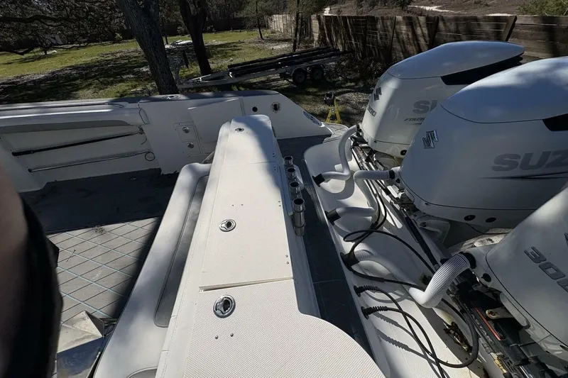 Slide: The Image of 2008 Wellcraft 35 Scarab Sport boat with dual Suzuki engines, outdoor setting. - 93