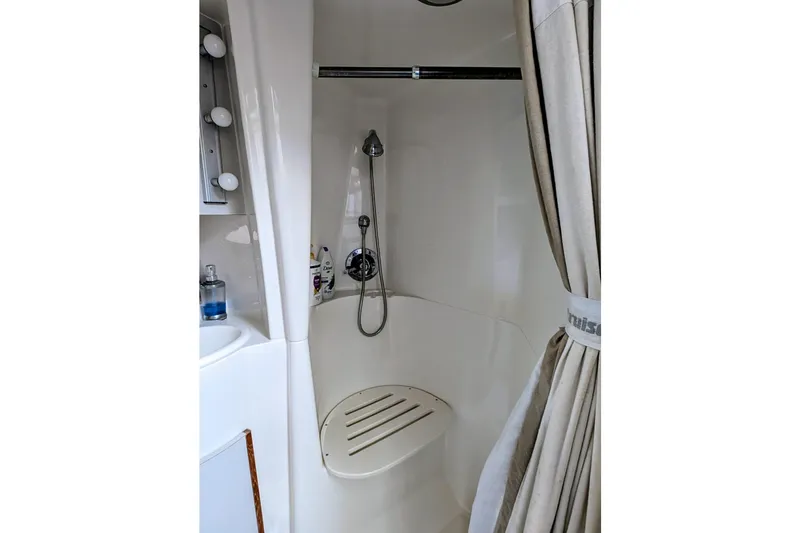 Slide: The Image of Shower area in 1994 Cruisers Yachts 3850 Aft Cabin with seat and curtain. - 10