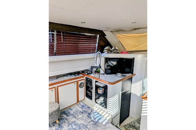 Slide: The Image of 1994 Cruisers Yachts 3850 Aft Cabin interior with kitchenette and cozy decor. - 14