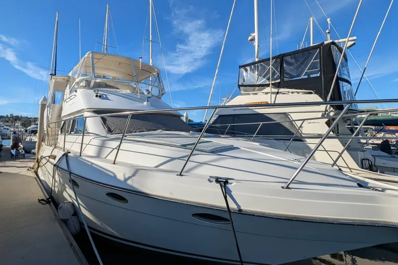 Slide: The Image of 1994 Cruisers Yachts 3850 Aft Cabin docked at marina under clear blue sky. - 18