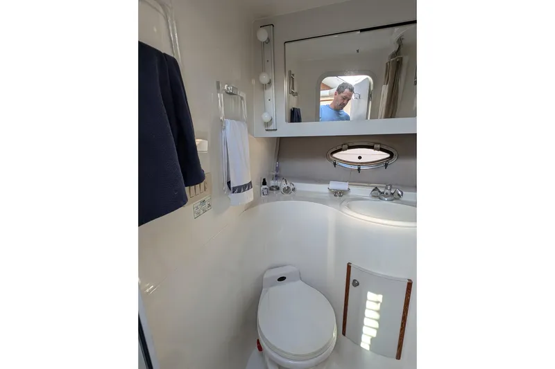 Slide: The Image of Bathroom interior of 1994 Cruisers Yachts 3850 Aft Cabin with mirror and porthole. - 19