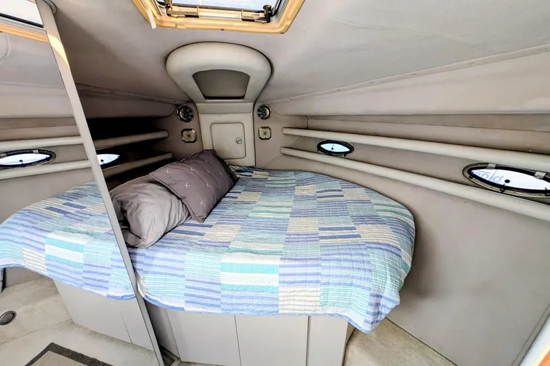 Slide: The Image of 1994 Cruisers Yachts 3850 Aft Cabin interior with cozy bed and nautical decor. - 2
