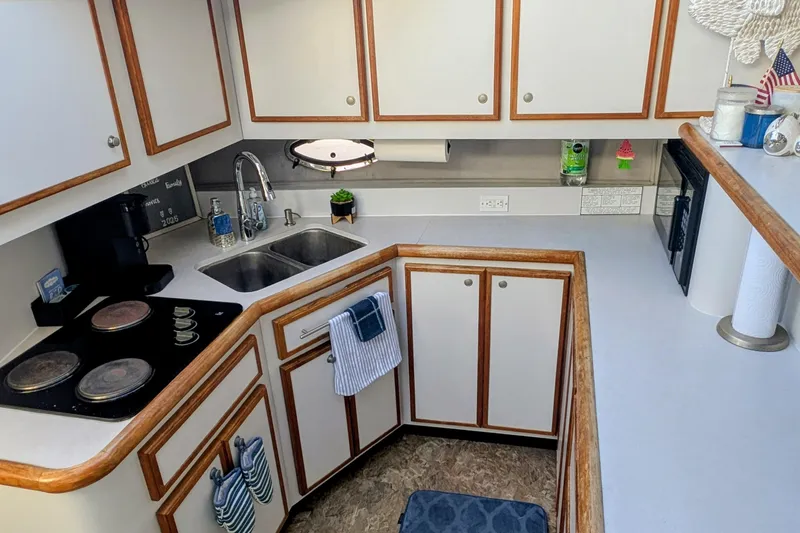 Slide: The Image of 1994 Cruisers Yachts 3850 Aft Cabin kitchen with modern amenities and stylish cabinetry. - 3