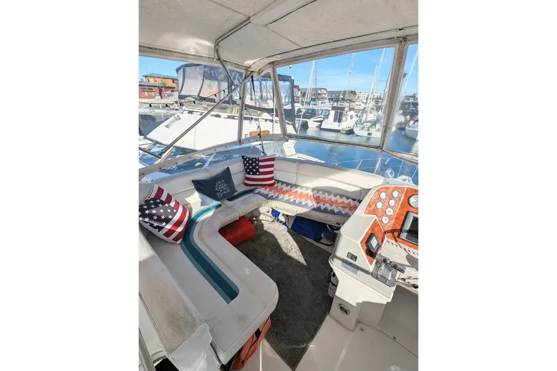 Slide: The Image of 1994 Cruisers Yachts 3850 Aft Cabin interior with seating and marina view. - 4