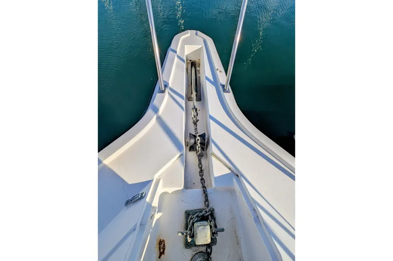 Slide: The Image of 1994 Cruisers Yachts 3850 Aft Cabin bow with anchor chain and calm water. - 8