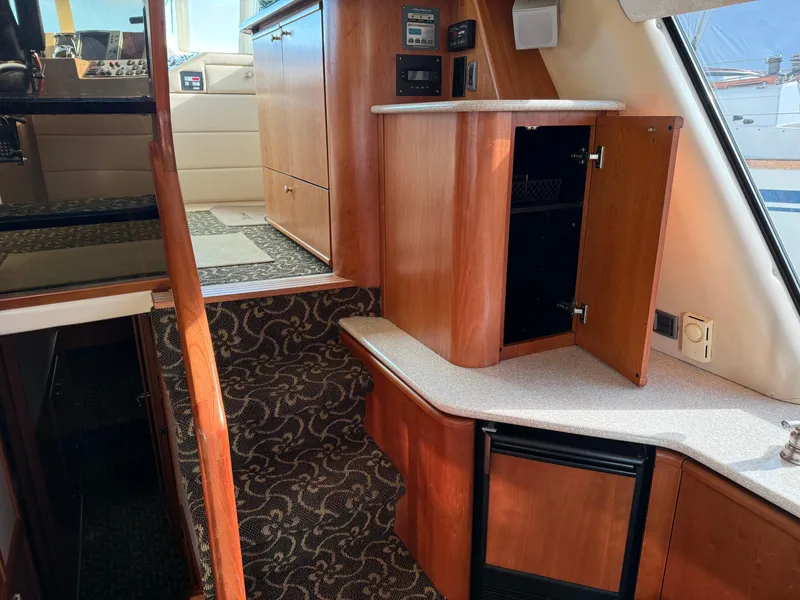 Slide: The Image of Interior of 2003 Meridian 490 Pilothouse with wood cabinetry and carpeted stairs. - 18