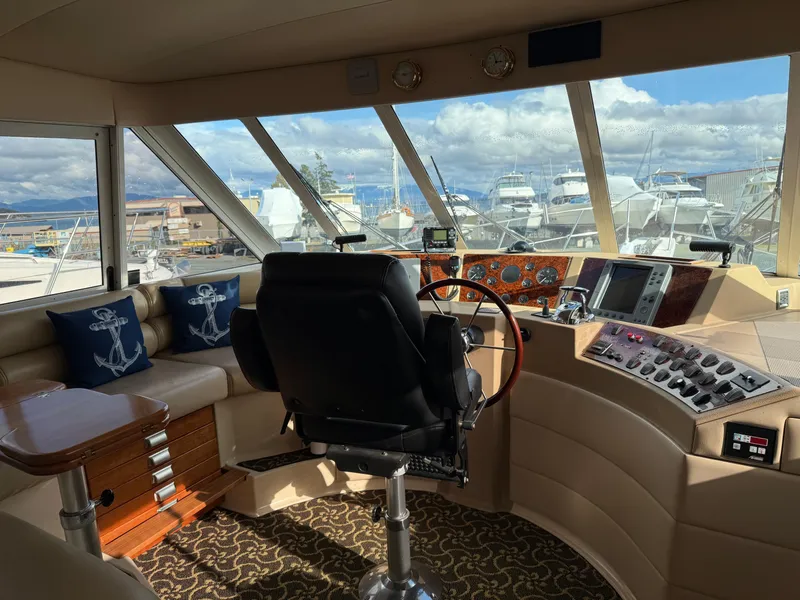 Slide: The Image of Pilothouse interior of 2003 Meridian 490 yacht with helm, seating, and nautical decor. - 20