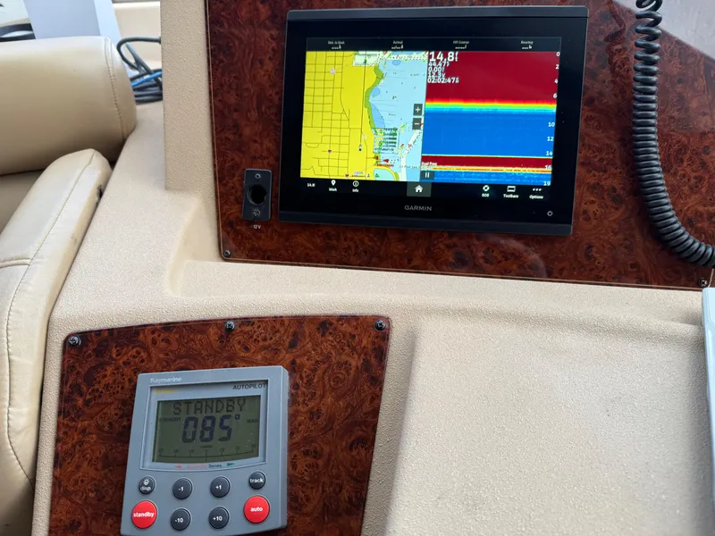 Slide: The Image of Control panel of 2003 Meridian 490 Pilothouse with navigation and autopilot displays. - 24