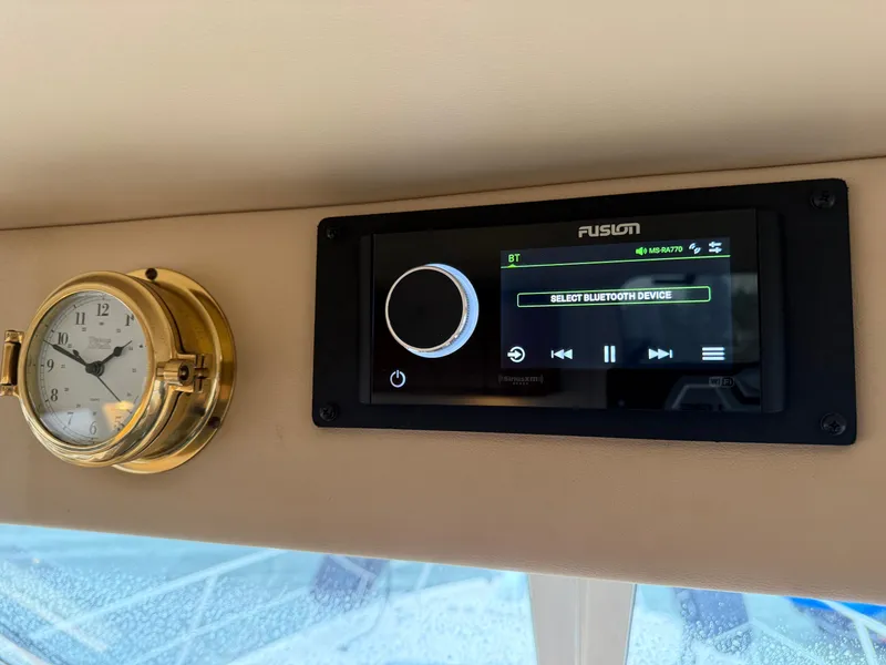 Slide: The Image of Fusion stereo and clock on 2003 Meridian 490 Pilothouse dashboard. - 26