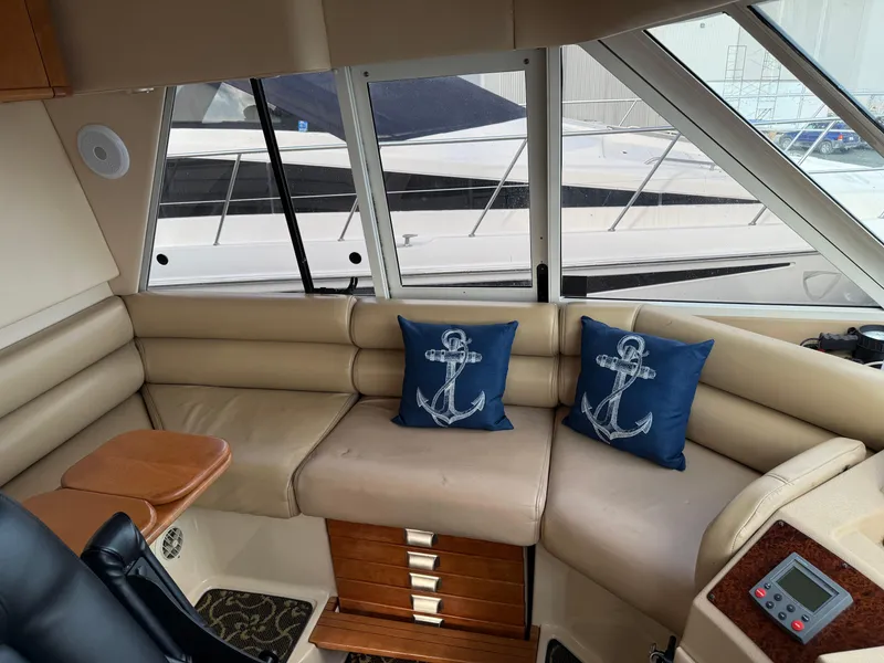 Slide: The Image of Interior of 2003 Meridian 490 Pilothouse with beige seating and nautical-themed cushions. - 31