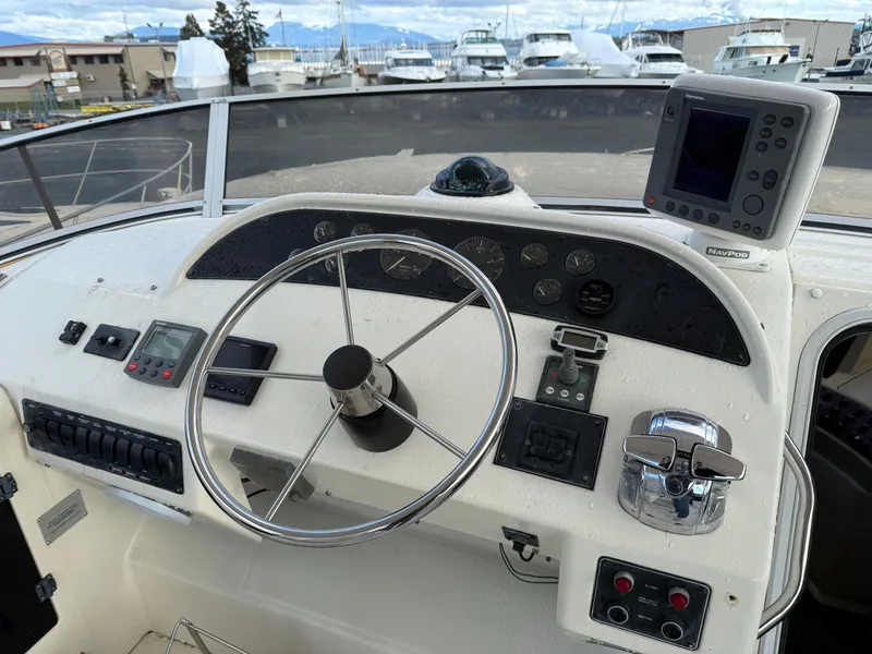 Slide: The Image of 2003 Meridian 490 Pilothouse helm with steering wheel and navigation equipment. - 36