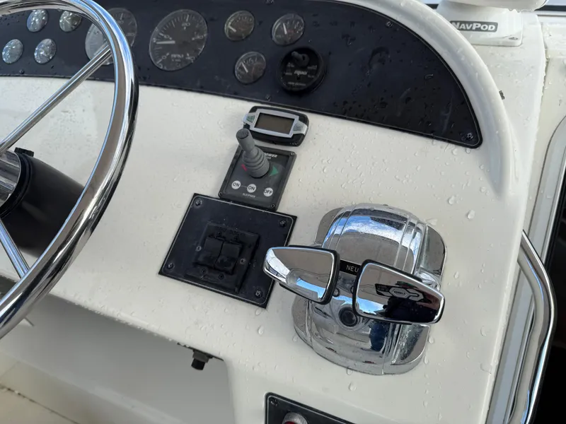 Slide: The Image of 2003 Meridian 490 Pilothouse helm with steering wheel and control panel. - 37