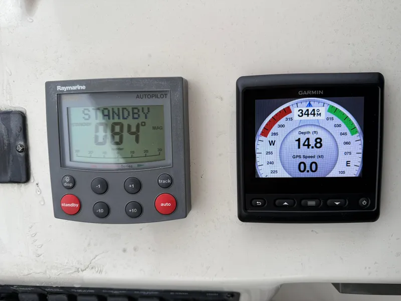 Slide: The Image of Autopilot and GPS displays on 2003 Meridian 490 Pilothouse boat dashboard. - 38