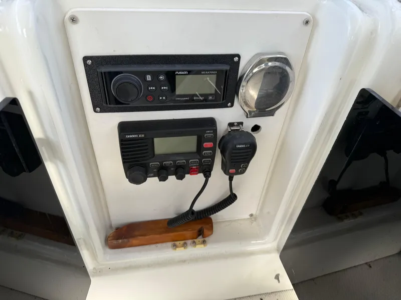 Slide: The Image of Control panel of a 2003 Meridian 490 Pilothouse boat with radio and navigation equipment. - 40