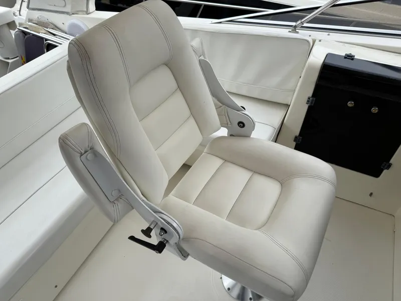 Slide: The Image of Captain's chair on 2003 Meridian 490 Pilothouse yacht, featuring white upholstery. - 42