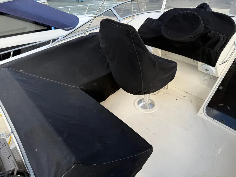 Slide: The Image of 2003 Meridian 490 Pilothouse boat interior with black seat covers. - 45