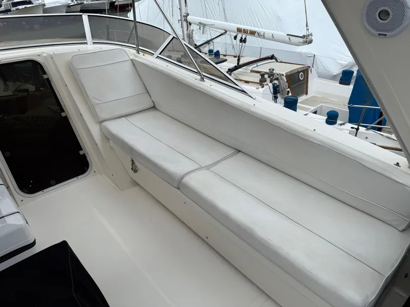 Slide: The Image of 2003 Meridian 490 Pilothouse boat with white cushioned seating area. - 46