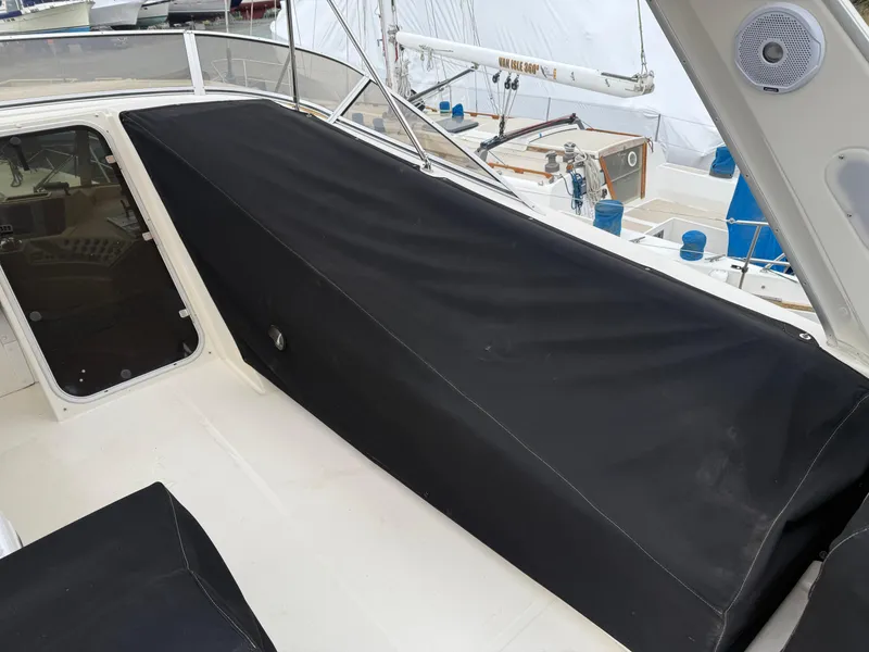 Slide: The Image of 2003 Meridian 490 Pilothouse boat with black cover on deck. - 47