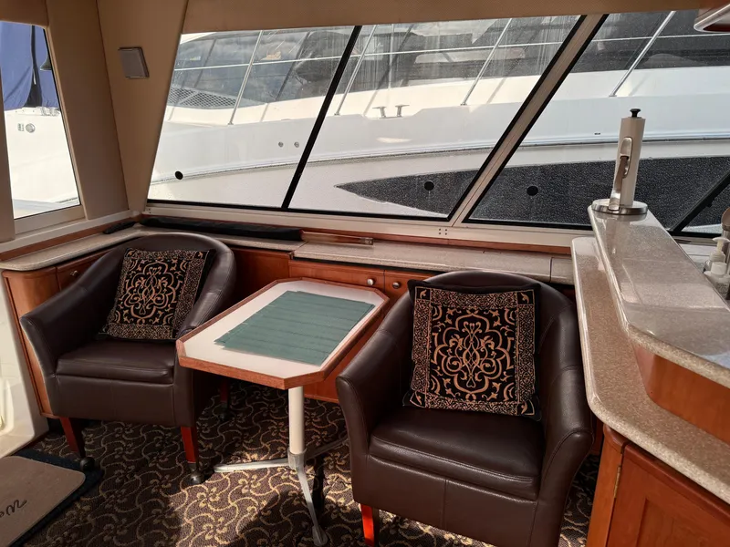 Slide: The Image of Interior of 2003 Meridian 490 Pilothouse with leather chairs and table, elegant design. - 7