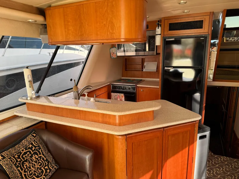 Slide: The Image of Interior of 2003 Meridian 490 Pilothouse yacht with modern kitchen and seating area. - 9