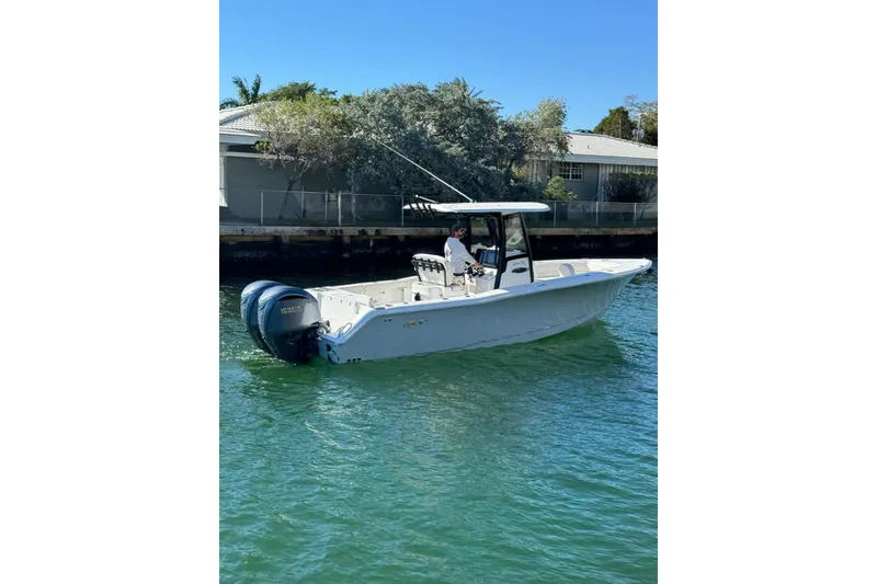 The Image of 2022 Sea Hunt Gamefish 27 boat with forward seating on calm water. - 1