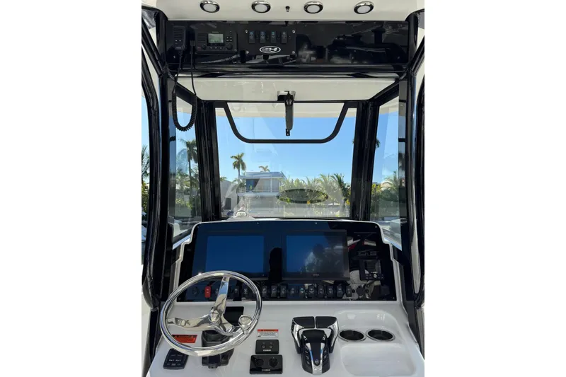 Slide: The Image of 2022 Sea Hunt Gamefish 27 boat dashboard with modern controls and dual screens. - 18