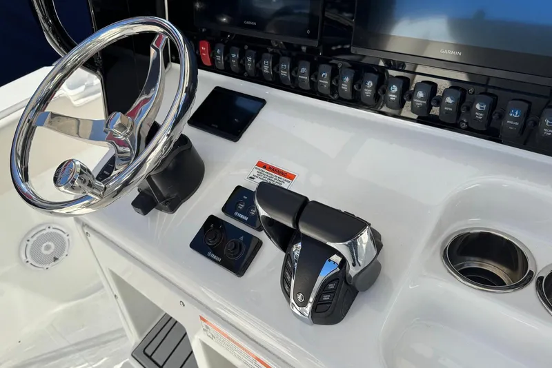 Slide: The Image of 2022 Sea Hunt Gamefish 27 helm with steering wheel and controls. - 19